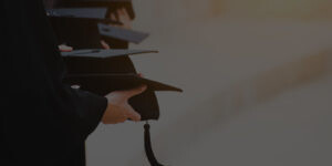 Students holding graduation caps