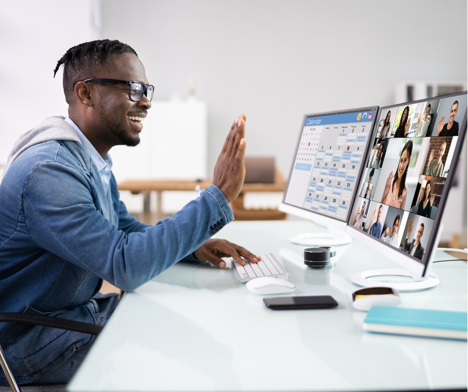 man on a professional conference call waving to the screen